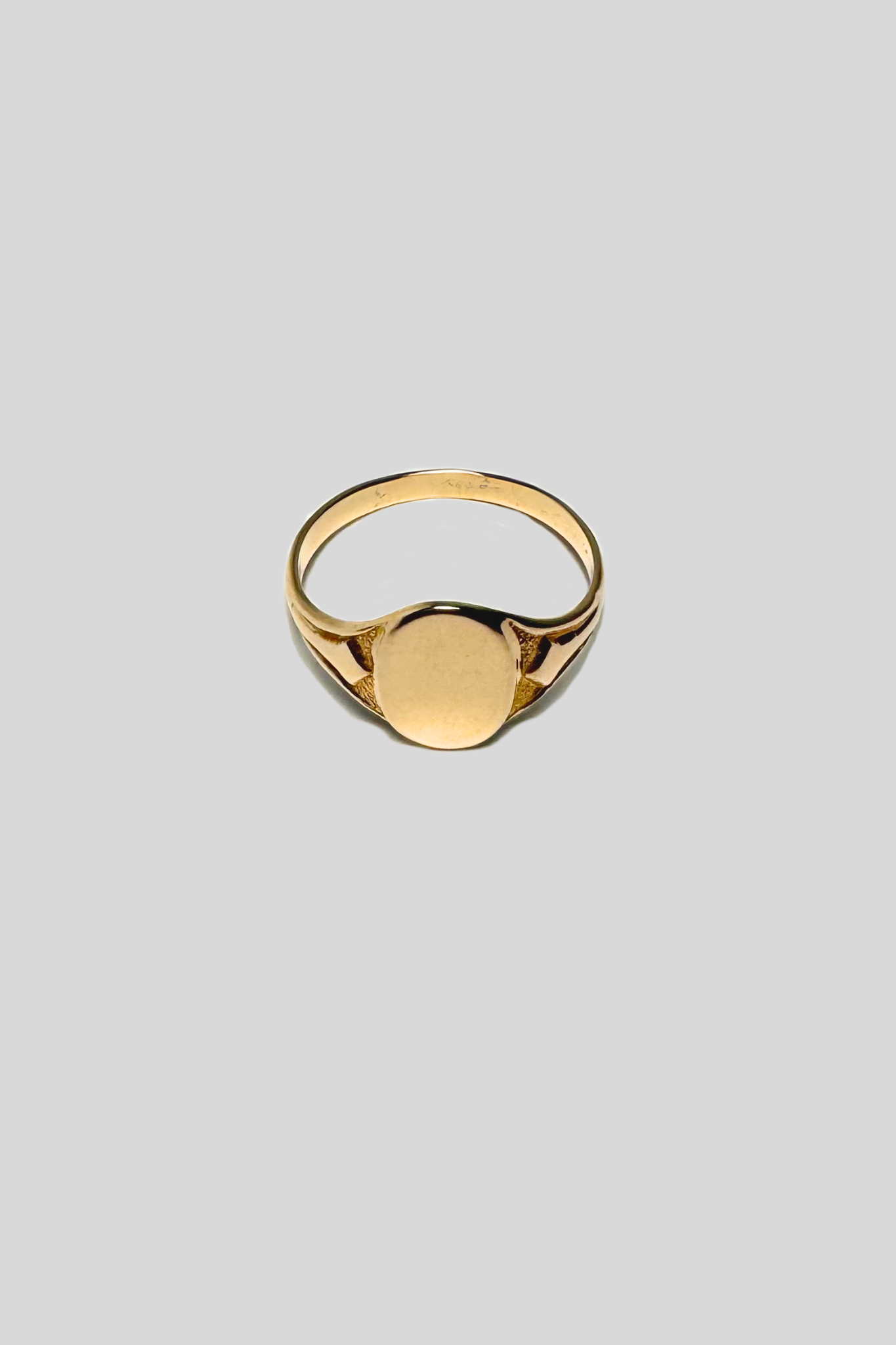 Gold ring on a light gray background