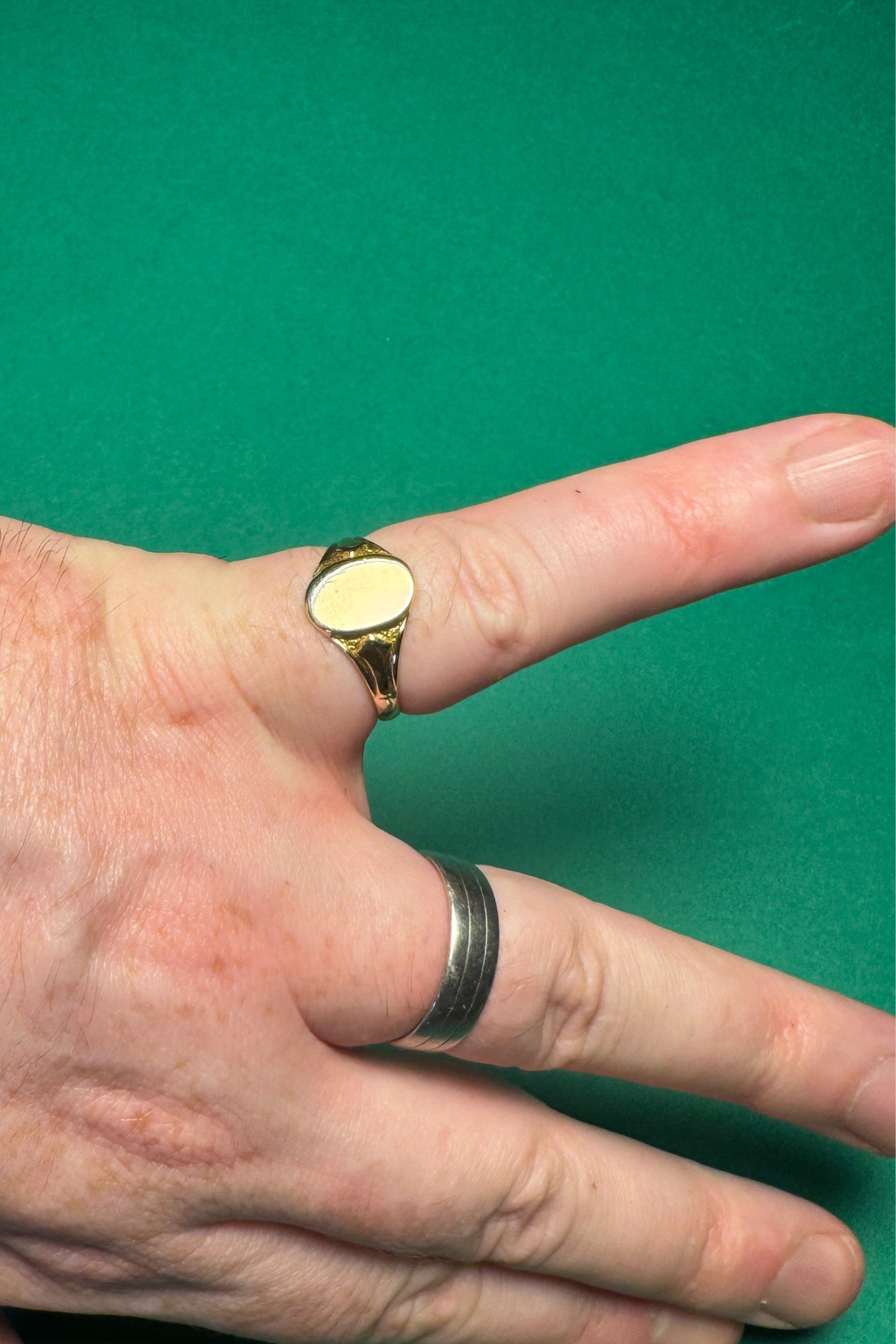 9 carat gold signet ring on green background